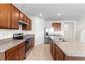 Bright kitchen featuring granite countertops and stainless steel appliances at 2024 Griffin Oaks Way, Tavares, FL 32778