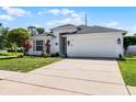 Well-maintained home with a two-car garage, manicured lawn, and minimalist landscaping that enhances curb appeal at 239 Bronze Leaf Ct, Apopka, FL 32703