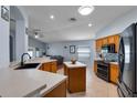 Open concept kitchen featuring stainless steel appliances, tile backsplash, and center island at 239 Bronze Leaf Ct, Apopka, FL 32703