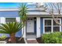Inviting front porch with a white door, lush landscaping, and modern exterior lighting for curb appeal at 2413 Weber St, Orlando, FL 32803