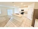 Open kitchen featuring an island with a sink and views of the carpeted living area at 2837 Palatino Lane, Tavares, FL 32778