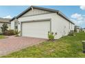 Well-kept home with a two-car garage, easy access to utilities and a well manicured lawn at 3069 Cassidy Ln, Haines City, FL 33844