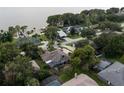 Aerial view of a lovely lakeside community with mature trees and private docks at 3111 Indian Trl, Eustis, FL 32726
