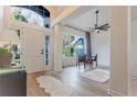 Bright foyer featuring a high ceiling, white door, and luxury vinyl flooring at 3111 Indian Trl, Eustis, FL 32726