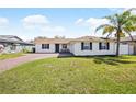 Charming single-story home with a well-maintained lawn, brick driveway, and a welcoming front porch at 3117 Shady Pine Ave, Winter Park, FL 32792