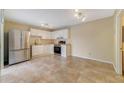 This kitchen offers tile flooring, stainless steel refrigerator, and white cabinetry at 4036 Shannon Brown Dr, Orlando, FL 32808