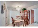 Elegant dining room with chandelier, set table, and decorative china cabinet at 4155 Westgate Rd, Orlando, FL 32808