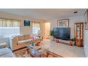 Cozy living room with large windows, tile floors, and comfortable furniture at 4155 Westgate Rd, Orlando, FL 32808