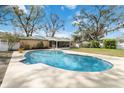 Inviting backyard oasis featuring a sparkling pool, a screened-in porch, and a spacious patio at 4227 Spring Ln, Lakeland, FL 33811