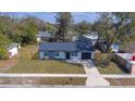 Charming single-story home with well-manicured lawn and a black door and a one car garage at 4536 San Sebastian Cir, Orlando, FL 32808