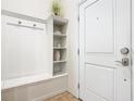 Hallway features built-in shelving, coat hooks, and seating area at 4594 Terrasonesta Dr, Davenport, FL 33837