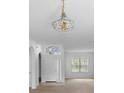 Bright entryway featuring tile flooring and a classic chandelier, leading to the open living spaces at 536 Kilimanjaro Dr, Kissimmee, FL 34758