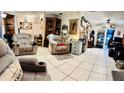 Spacious living room featuring tile floors, recliners, and decorative wall hangings providing a comfortable gathering space at 5371 Tribune Dr, Orlando, FL 32812