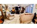 Cozy living room features tile floors, a fireplace, and recliner chairs for comfortable gathering at 5371 Tribune Dr, Orlando, FL 32812