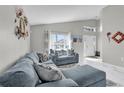 Inviting living room showcasing a plush sectional sofa, high ceilings, and plenty of natural light at 551 Majesty Dr, Davenport, FL 33837