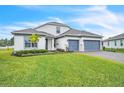 Charming two-story home with a well-maintained lawn and a brick paved driveway at 6105 Citrus Grove Ct, St Cloud, FL 34771