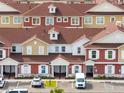 Overhead view of townhomes showcasing consistent design, landscaping, and parking areas within the community at 7558 Sunflower Cir, Kissimmee, FL 34747