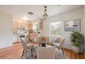 Cozy eat-in kitchen with a chandelier, warm wood floors, and stainless appliances at 858 Darwin Dr, Altamonte Springs, FL 32701