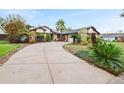 Inviting single-story home featuring xeriscaping, desert landscaping, and a concrete driveway at 872 Huckleberry Ln, Winter Springs, FL 32708