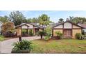 Inviting single-story home featuring xeriscaping, desert landscaping, and a concrete driveway at 872 Huckleberry Ln, Winter Springs, FL 32708