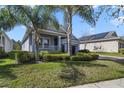 Single-Gathering home featuring a well-maintained lawn, brick-paved driveway, and an attached two-car garage at 10012 Lovegrass Ln, Orlando, FL 32832