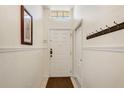 Bright foyer featuring a coat rack, neutral walls and a window above the front door at 1025 Sandy Ridge Dr, Davenport, FL 33896