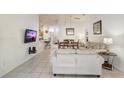 Open concept living room and dining area with tile flooring and lots of natural light at 1025 Sandy Ridge Dr, Davenport, FL 33896