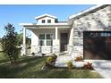 Charming home with stone accents, covered porch, manicured lawn, and a patterned walkway at 1038 Dennis Ave, Orlando, FL 32807