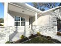 Covered front porch with stone detailing, providing a welcoming entrance to the home at 1038 Dennis Ave, Orlando, FL 32807