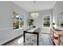 Bright dining room featuring a stylish chandelier and large windows at 13864 Sachs Ave, Orlando, FL 32827