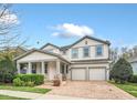 Charming two-story home with a manicured lawn, brick driveway, and a welcoming front porch with stone accents at 14150 Aldford Dr, Winter Garden, FL 34787