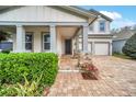 Inviting front porch with stone accents and a brick walkway, perfect for enjoying the outdoors at 14150 Aldford Dr, Winter Garden, FL 34787