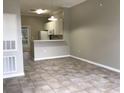 Open-concept living room features tile floors and adjoins the kitchen with a breakfast bar at 145 Reserve Cir # 113, Oviedo, FL 32765