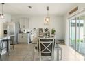 Bright dining area featuring a dining table, sliding glass doors to the patio, and decorative lighting at 1775 Copinger Ter, Kissimmee, FL 34744