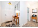 Bright entryway featuring wood-look tile flooring, a console table, and decorative mirrors, creating a welcoming space at 1920 Perch Hammock Loop, Groveland, FL 34736