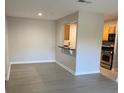 The living room area, showing light-colored walls and floors, with a pass-through to the kitchen at 2025 Dixie Belle Dr # 2025 B, Orlando, FL 32812