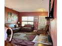 Living Room with red walls, two sofas, a large window, and a patterned rug at 214 Great Yarmouth Ct, Kissimmee, FL 34758