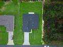 Overhead view of a neatly landscaped house and yard, showcasing the roof and surrounding greenery at 2246 Sw 167Th Pl, Ocala, FL 34475