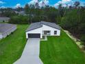 Aerial view of a well-manicured property with green lawn and modern single-story home at 2246 Sw 167Th Pl, Ocala, FL 34475