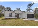 Stylish single-story home with modern design, dark-framed windows, and a two-car garage at 2483 Sw 163Rd Pl, Ocala, FL 34473