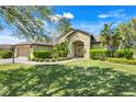 Charming home showcasing lush landscaping and a welcoming front entrance at 27127 Stoney Brook Dr, Leesburg, FL 34748