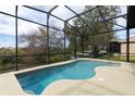 Private screened-in pool offers a refreshing outdoor oasis with a view at 27127 Stoney Brook Dr, Leesburg, FL 34748