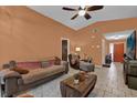 Cozy living room with neutral tile floors, ceiling fan, and comfortable furnishings at 3038 Woolridge Dr, Orlando, FL 32837