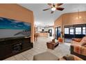 Bright, open-concept living area with tile floors, seamlessly connecting living and kitchen spaces at 3038 Woolridge Dr, Orlando, FL 32837