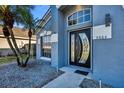 Close up of the front door entrance that features an arched transom window above a decorative door at 3664 Sickle St, Orlando, FL 32812