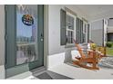 Close-up of a cozy front porch with rocking chairs and a decorative wreath on the front door at 3916 Clipstone Pl, Sanford, FL 32773