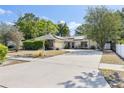 Charming single-story home with lush landscaping, solar panels, and a spacious concrete driveway at 5267 Crisfield Ct, Orlando, FL 32808