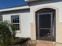 Welcoming entrance featuring a screen door, a window, and a charming archway at 622 Samuel Pl, Davenport, FL 33837