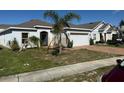 Attractive single-story home featuring a brick driveway and a two-car garage at 622 Samuel Pl, Davenport, FL 33837