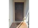 Elegant front door with panels and a welcome mat, inviting entry to the home at 622 Samuel Pl, Davenport, FL 33837